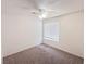 Cozy bedroom with neutral carpet, ceiling fan and a window for natural light at 2753 Devita Cir, Las Vegas, NV 89117