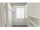 Walk-in closet with neutral carpet, shelving, and a window at 2753 Devita Cir, Las Vegas, NV 89117