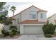 Charming home featuring a two-car garage, desert landscaping, and a classic tile roof at 2753 Devita Cir, Las Vegas, NV 89117