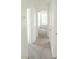 Hallway showing carpeted floors and white walls leading to a bedroom featuring a window at 2753 Devita Cir, Las Vegas, NV 89117