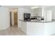 Bright kitchen featuring a breakfast bar, white cabinetry, and black appliances at 2753 Devita Cir, Las Vegas, NV 89117