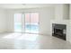 Spacious living room with tile floors, sliding glass doors and cozy fireplace at 2753 Devita Cir, Las Vegas, NV 89117