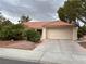 Lovely single-story residence showcasing a terracotta roof, two-car garage, and beautifully landscaped front yard at 2801 Golfside Dr, Las Vegas, NV 89134