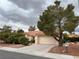 Charming single-story home with a terracotta roof, landscaped front yard, and a spacious two-car garage at 2801 Golfside Dr, Las Vegas, NV 89134