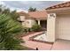 Inviting front entrance with a tiled walkway, mature landscaping, and classic architectural details at 2801 Golfside Dr, Las Vegas, NV 89134