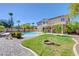 A backyard featuring a refreshing pool area, lush landscaping, and a covered patio at 281 Powerbilt Ave, Las Vegas, NV 89148