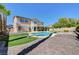 Private backyard with pool, spa, putting green, patio, and desert landscaping at 281 Powerbilt Ave, Las Vegas, NV 89148