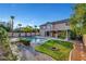 Private backyard showcasing a large pool, mature trees, lush grass, and a cozy outdoor seating area at 281 Powerbilt Ave, Las Vegas, NV 89148