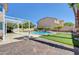 Beautiful backyard with a pool, putting green, and covered patio for outdoor entertainment at 281 Powerbilt Ave, Las Vegas, NV 89148