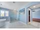 Bathroom showcasing soaking tub, walk-in shower with seat, and doorway to custom closet at 281 Powerbilt Ave, Las Vegas, NV 89148