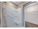 White tiled shower with built-in seat and access to a walk-in closet at 281 Powerbilt Ave, Las Vegas, NV 89148