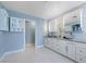 Bathroom featuring dual vessel sinks, white cabinetry, and a doorway to another room at 281 Powerbilt Ave, Las Vegas, NV 89148