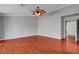 This primary bedroom features wood floors, neutral walls, and a ceiling fan at 281 Powerbilt Ave, Las Vegas, NV 89148