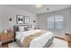 Bright bedroom featuring a gray bed frame, white linens, and sconce lighting at 281 Powerbilt Ave, Las Vegas, NV 89148