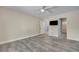 Bright bedroom featuring wood-look tile flooring, a TV, and access to a closet at 281 Powerbilt Ave, Las Vegas, NV 89148