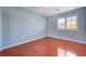 Bedroom featuring hardwood floors and a window with plantation shutters at 281 Powerbilt Ave, Las Vegas, NV 89148