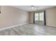Bright bedroom with wood-look tile flooring and a window with plantation shutters at 281 Powerbilt Ave, Las Vegas, NV 89148