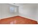 Bedroom features wood-look floors and a window with white blinds at 281 Powerbilt Ave, Las Vegas, NV 89148