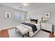 Cozy bedroom with white tufted headboard, bench, and framed botanical art at 281 Powerbilt Ave, Las Vegas, NV 89148