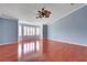 A bedroom showcasing hardwood floors, a ceiling fan and a window with plantation shutters at 281 Powerbilt Ave, Las Vegas, NV 89148