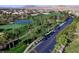 Scenic aerial view of the golf course community lined with palm trees, fairways and lush green landscaping at 281 Powerbilt Ave, Las Vegas, NV 89148
