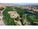 Beautiful aerial view of a golf course, showing manicured greens, water features, and luxury homes nearby at 281 Powerbilt Ave, Las Vegas, NV 89148