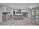 Bright kitchen with large island, stainless appliances, gray cabinets, and modern lighting at 281 Powerbilt Ave, Las Vegas, NV 89148