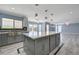 Kitchen view of open concept with island, pool view, stainless sink, and modern lighting at 281 Powerbilt Ave, Las Vegas, NV 89148