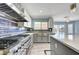 Well-equipped kitchen showcasing stainless steel appliances, a cooktop, and a large island at 281 Powerbilt Ave, Las Vegas, NV 89148