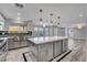 Spacious kitchen featuring a large island, stainless steel appliances, and modern lighting fixtures at 281 Powerbilt Ave, Las Vegas, NV 89148