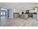 Modern kitchen with island, stainless steel appliances, and stylish white and gray cabinetry at 281 Powerbilt Ave, Las Vegas, NV 89148