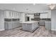 Well-lit kitchen with modern design, large island, stainless steel appliances, and sleek backsplash at 281 Powerbilt Ave, Las Vegas, NV 89148
