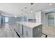 Open-concept kitchen with a large center island, modern lighting, and stylish finishes at 281 Powerbilt Ave, Las Vegas, NV 89148