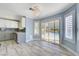Kitchen nook featuring pool view, modern lighting, and sleek gray cabinets at 281 Powerbilt Ave, Las Vegas, NV 89148
