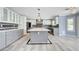 Spacious kitchen featuring a large island, gray cabinets, stainless steel appliances, and modern lighting at 281 Powerbilt Ave, Las Vegas, NV 89148
