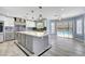 Chic kitchen with island, modern fixtures, and seamless access to the backyard pool area at 281 Powerbilt Ave, Las Vegas, NV 89148