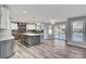 Open-concept kitchen featuring an island, modern appliances, and access to the backyard pool at 281 Powerbilt Ave, Las Vegas, NV 89148