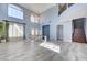 Open-concept living area with staircase, lots of natural light, and stylish tile flooring at 281 Powerbilt Ave, Las Vegas, NV 89148
