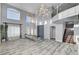 Open floorplan with soaring ceilings, large windows, and elegant chandelier lighting at 281 Powerbilt Ave, Las Vegas, NV 89148