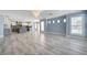 Open living space connecting to the kitchen, featuring tiled floors and shuttered windows at 281 Powerbilt Ave, Las Vegas, NV 89148