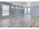 Bright living room with shuttered windows and stylish wood-look tile flooring at 281 Powerbilt Ave, Las Vegas, NV 89148