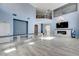 Spacious living room with a fireplace, sleek tiled floors, and access to upper level at 281 Powerbilt Ave, Las Vegas, NV 89148