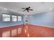 Spacious living room with glossy wood floors, modern ceiling fan, and plenty of natural light at 281 Powerbilt Ave, Las Vegas, NV 89148