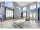 Bright living room with high ceilings, large windows, and elegant chandelier at 281 Powerbilt Ave, Las Vegas, NV 89148