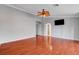 Main bedroom with wood-look floors, ceiling fan, and mounted television at 281 Powerbilt Ave, Las Vegas, NV 89148