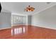 Large main bedroom with wood-look floors, ceiling fan, and bay windows at 281 Powerbilt Ave, Las Vegas, NV 89148