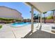 Relaxing covered patio overlooking the sparkling pool and well-manicured backyard at 281 Powerbilt Ave, Las Vegas, NV 89148