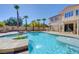 Backyard pool and spa with view of the house and covered patio at 281 Powerbilt Ave, Las Vegas, NV 89148