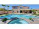 An inviting pool and spa surrounded by patio with a covered outdoor living space at 281 Powerbilt Ave, Las Vegas, NV 89148