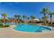 Resort-style community pool surrounded by palm trees, lounge chairs, and splash pad water features at 281 Powerbilt Ave, Las Vegas, NV 89148